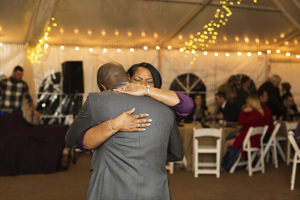 Groom dancing with mother at reception