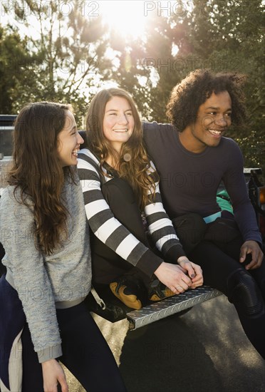 Friends sitting together in truck bed