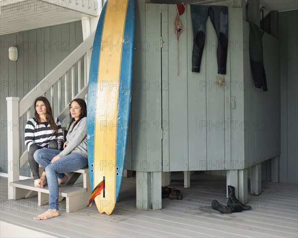 Surfers relaxing on patio