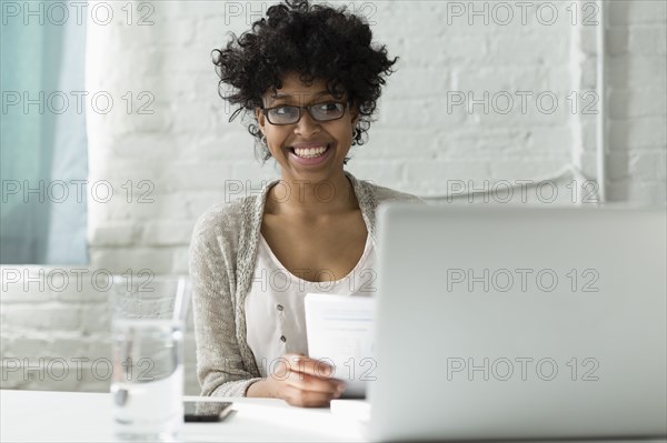 Mixed race architect working at desk