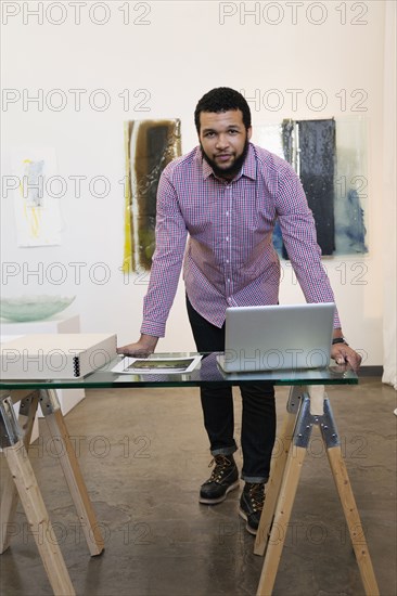 Mixed race man working in art gallery