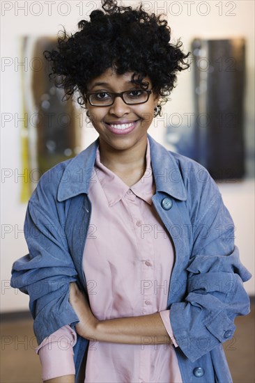 Mixed race woman smiling in art gallery