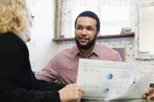 Businesswoman talking to young businessman