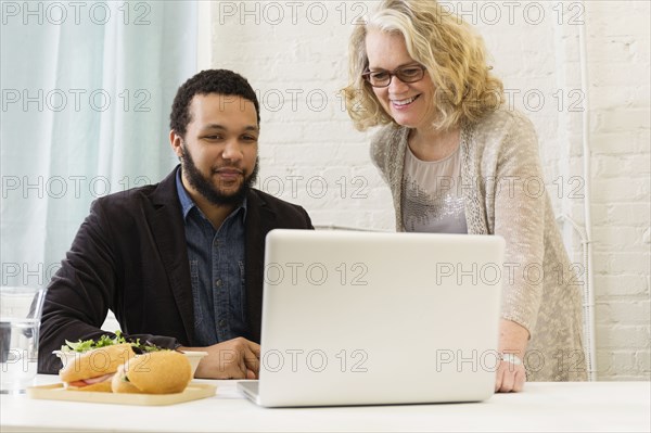 Business people having lunch together in office