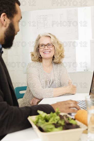 Business people having lunch together in office