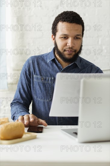 Mixed race businessman working at desk