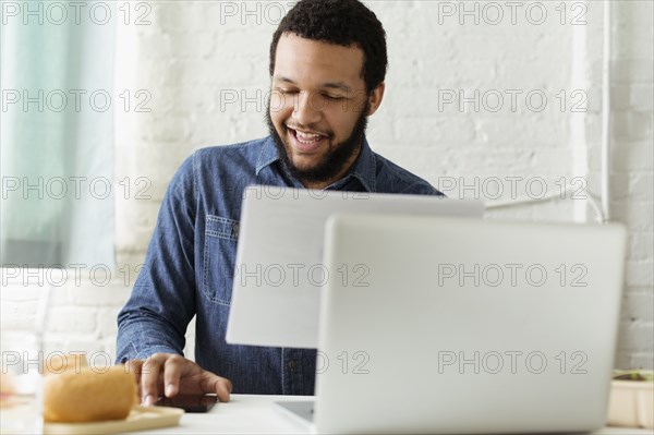 Mixed race businessman working at desk