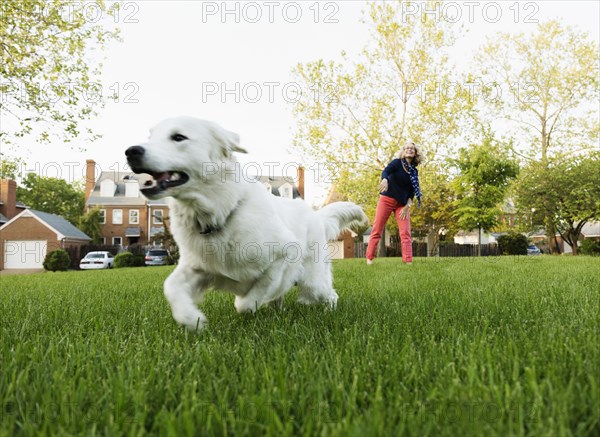 Caucasian woman playing with dog in park