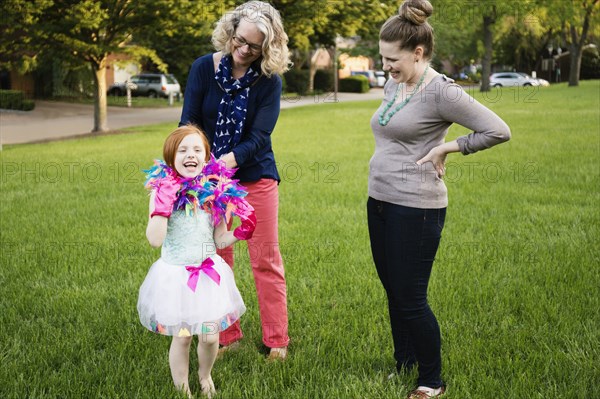 Three generations of Caucasian women standing in park