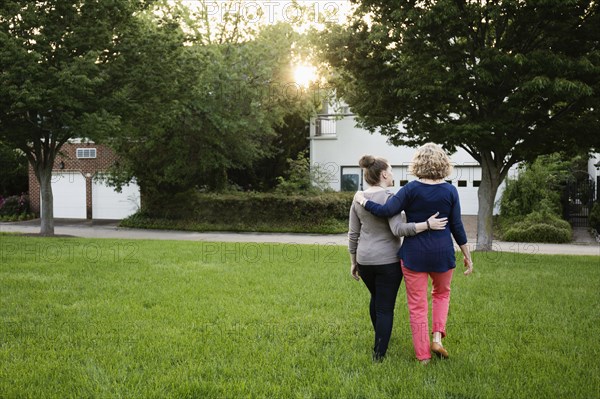 Caucasian mother and daughter walking in park