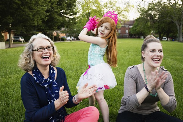 Three generations of Caucasian women relaxing in park