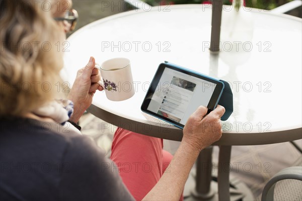 Caucasian woman using tablet computer outdoors