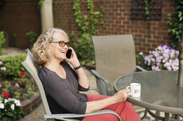 Caucasian woman talking on cell phone outdoors