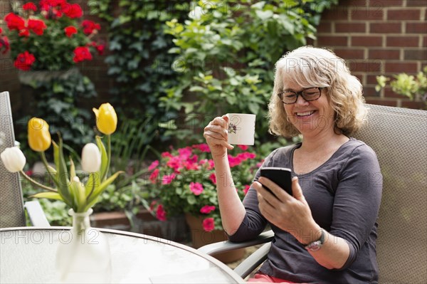 Caucasian woman using cell phone outdoors