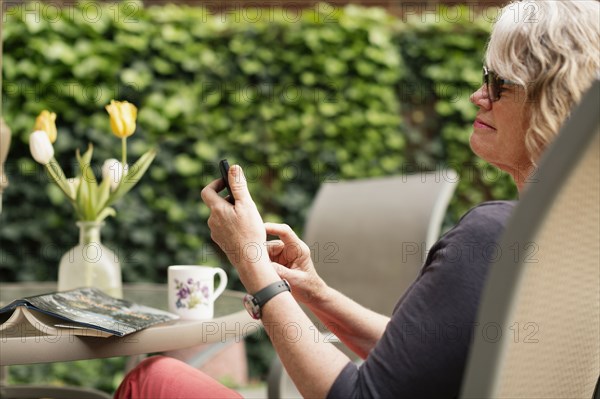 Caucasian woman using cell phone outdoors