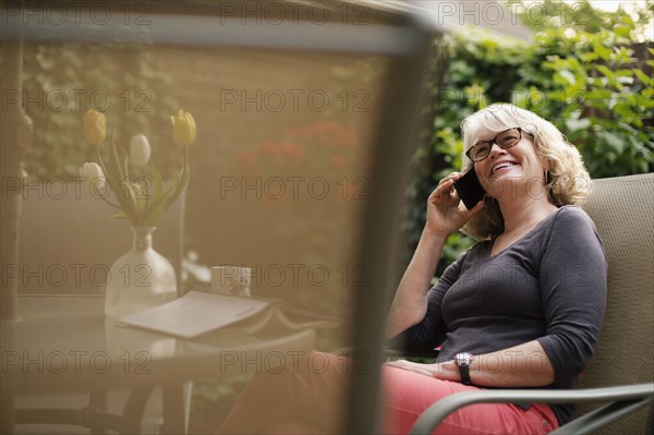 Caucasian woman talking on cell phone outdoors