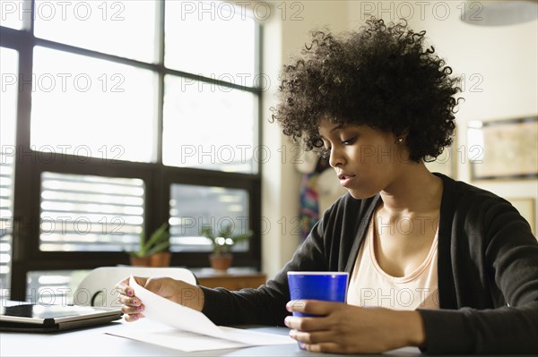 Mixed race businesswoman working in office