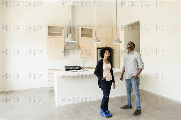 Couple standing in kitchen in new house