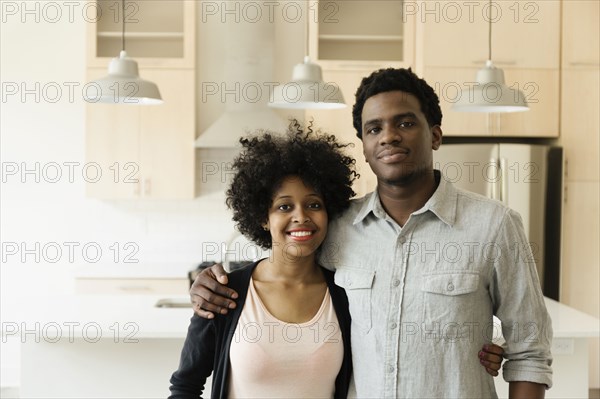 Couple hugging in kitchen in new house