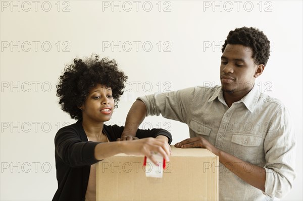 Couple packing cardboard box