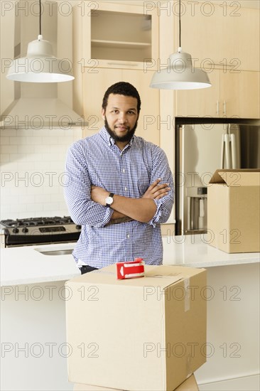 Mixed race man standing in new house