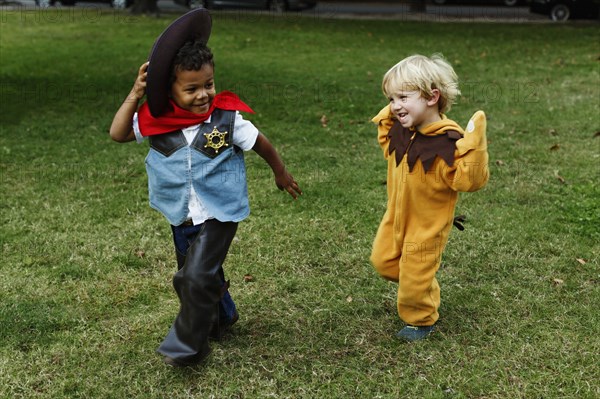 Boys playing in costumes in park