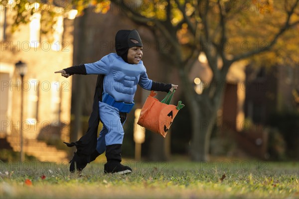 African American boy trick-or-treating on Halloween