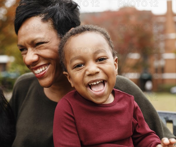 Close up of African American mother and son laughing