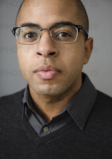 Close up of mixed race man wearing eyeglasses