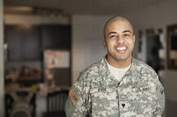 Mixed race man smiling in living room