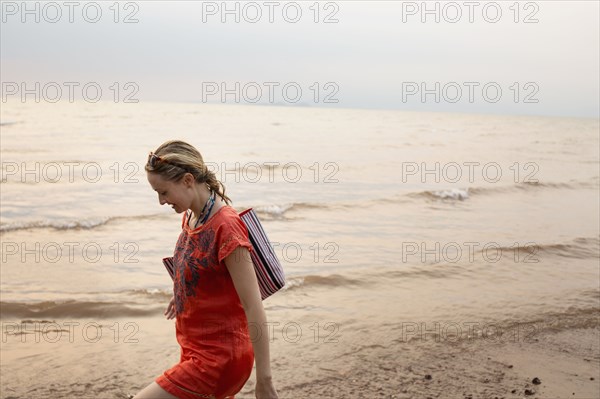 Caucasian woman walking on beach