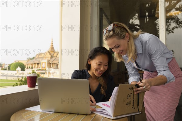 Businesswomen working together in cafe