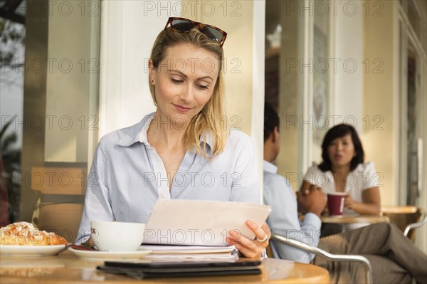 Businesswoman using digital tablet in cafe