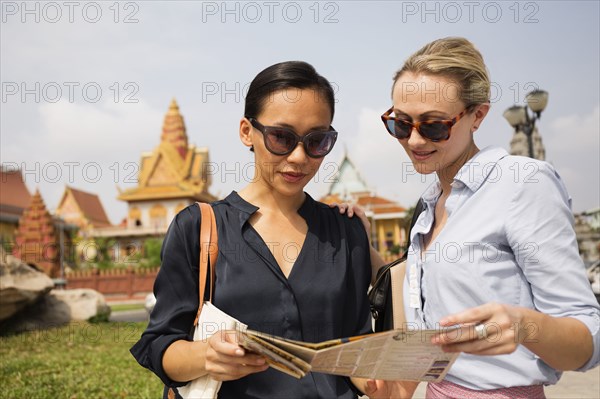 Tourists reading map near temple