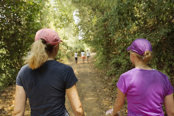 Women walking on remote dirt path