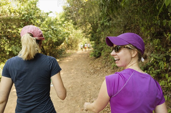 Women walking on remote dirt path