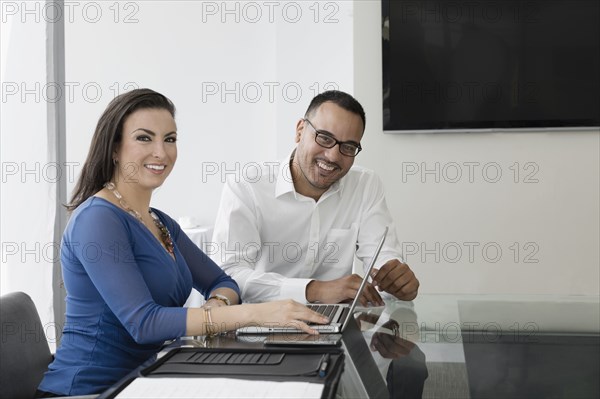 Business people smiling in conference room