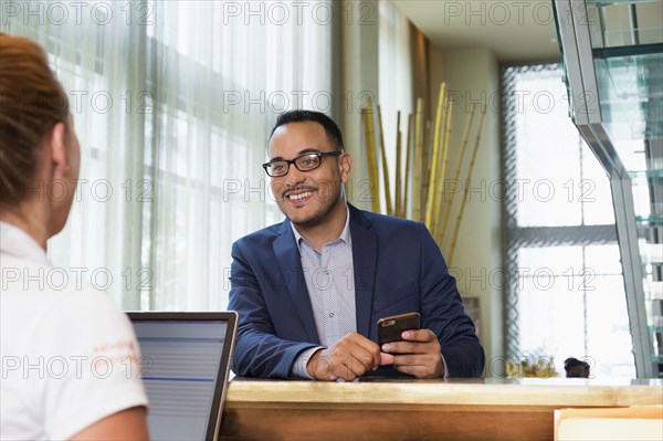 Businessman checking into hotel with concierge