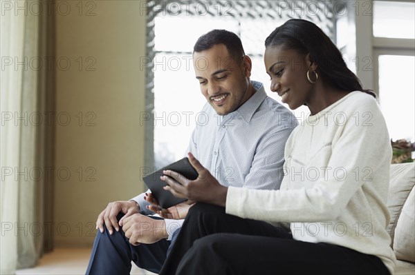 Business people using digital tablet in hotel lobby