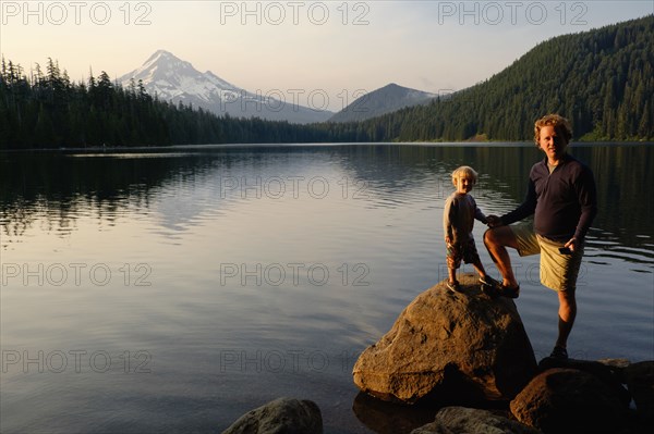 Caucasian father and son standing by Lost Lake