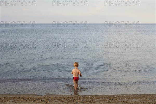 Caucasian boy playing on beach