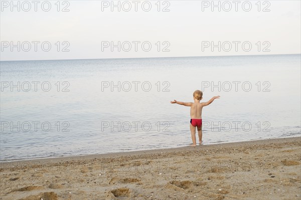 Caucasian boy playing on beach