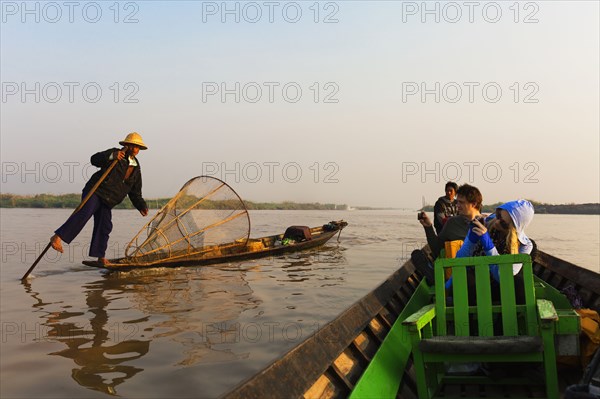 Tourists riding in canoe on rural lake