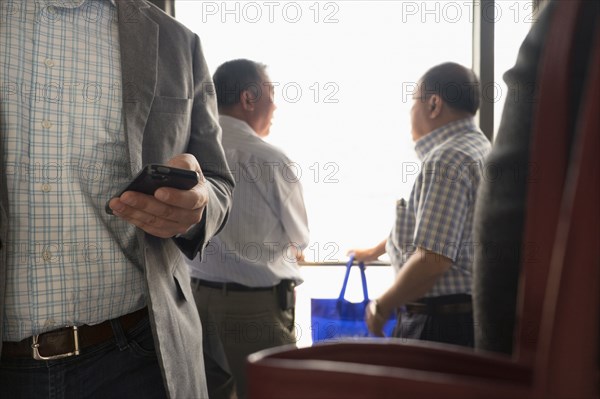 Businessman using cell phone in airport