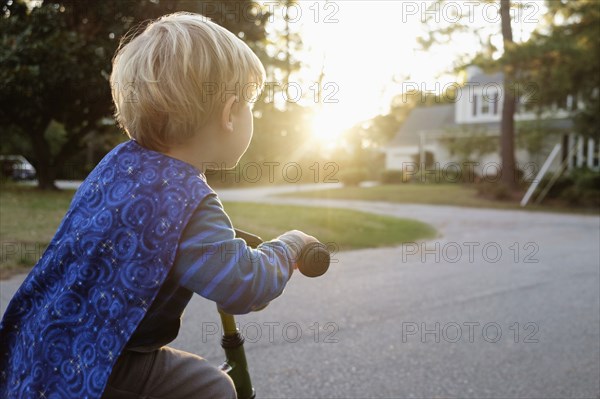 Caucasian boy riding bicycle