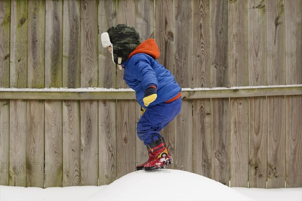 Caucasian boy playing in snow