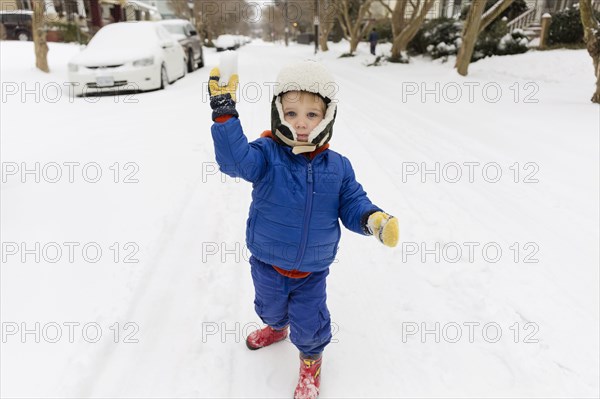 Caucasian boy throwing snowball