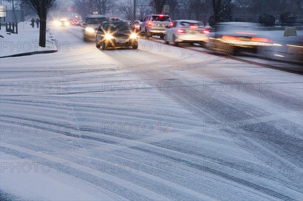Traffic driving on snowy street