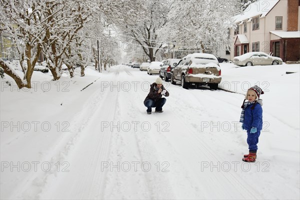 Caucasian mother and son playing in snow