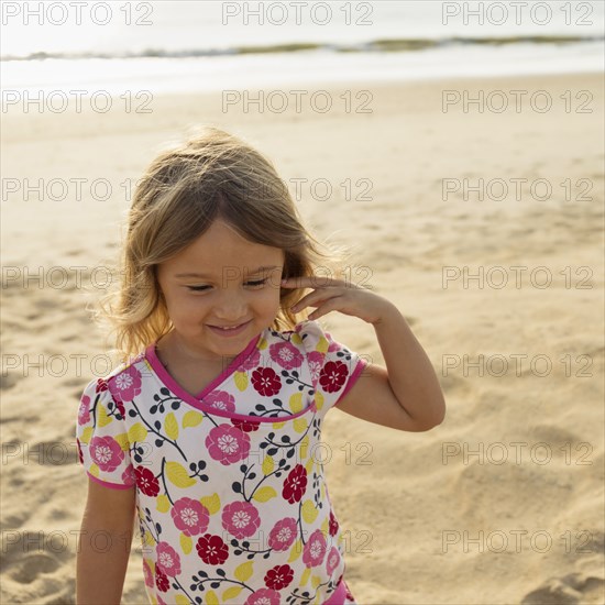 Mixed race girl smiling on beach